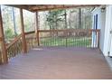 View of the spacious covered porch overlooking a grassy yard at 59 Pine Ridge Ln, White, GA 30184