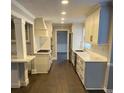 Well-lit kitchen with white cabinets, marble countertops, and stainless steel appliances at 1095 Willow Bnd, Roswell, GA 30075