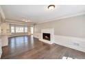 Bright living room features a fireplace, hardwood floors, and large windows that provide natural light at 1095 Willow Bnd, Roswell, GA 30075