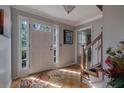 Inviting foyer with hardwood floors, sidelight windows and staircase leading to the upper level at 1527 Ridgewood Sw Dr, Lilburn, GA 30047