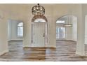 Elegant foyer with hardwood floors, arched doorways and modern chandelier at 3535 Southmont Ct, Cumming, GA 30041