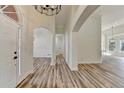 Spacious foyer showcasing hardwood floors, arched doorways, and modern lighting at 3535 Southmont Ct, Cumming, GA 30041