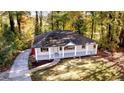 Inviting exterior view of a cozy home featuring a quaint porch and a lush green yard at 610 Walnut Sw Pl, Marietta, GA 30060