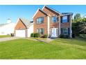 Attractive two-story brick home featuring a manicured lawn and welcoming entrance at 6251 Lamp Post Pl, Atlanta, GA 30349