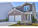 Charming two-story home features a two-car garage, brick accents, and well-maintained landscaping at 3928 Hester St, Duluth, GA 30097