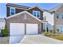 Charming two-story home features a two-car garage, brick accents, and well-maintained landscaping at 3928 Hester St, Duluth, GA 30097