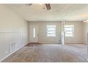 Open living room featuring new carpet, a bright window, and fresh paint at 6050 Randy Ln, Ellenwood, GA 30294