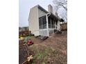 Cozy screened-in porch and backyard featuring a lush garden and well-kept lawn at 1672 Cedar Bluff Way, Marietta, GA 30062