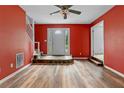 Bright living room with a stone accent, front door, and wood-look flooring at 115 Louise Ln, Villa Rica, GA 30180