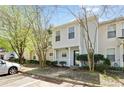 Street view of a well-maintained two-story townhome, featuring a small porch, neat landscaping, and easy parking access at 2376 Wellington Cir, Lithonia, GA 30058