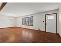 Inviting living room features hardwood floors, a front door with glass, and plenty of natural light at 415 Creek Valley Dr, Woodstock, GA 30188