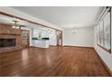 Bright living room with hardwood floors, fireplace, and natural light; open layout to the kitchen at 415 Creek Valley Dr, Woodstock, GA 30188