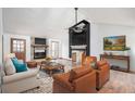 Spacious living room featuring a vaulted ceiling, stone fireplace, neutral tones, and hardwood floors at 804 Allatoona Crst, Woodstock, GA 30189