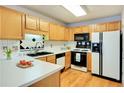 Bright kitchen with white countertops, appliances, and wood cabinetry, creating a functional cooking space at 1029 Daventry Xing, Woodstock, GA 30188