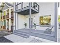 Stylish front porch with grey wood, seating, and modern lighting at 179 South Se Ave, Atlanta, GA 30315