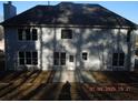 Rear view of a two-story home with a neutral color scheme and a patio at 3975 Broadleaf Walk, Ellenwood, GA 30294