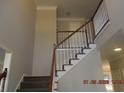 View of the carpeted staircase with white and brown trim and light grey walls at 3975 Broadleaf Walk, Ellenwood, GA 30294