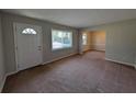 Inviting living room with neutral paint, carpet flooring and ample natural light at 8271 Walnut Dr, Jonesboro, GA 30238