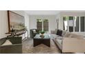 Sunlit living room featuring stylish furnishings, a sliding glass door, and neutral decor at 9 Ivy Gates Ne, Atlanta, GA 30342