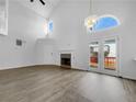 Bright living room with vaulted ceilings, fireplace, and access to a deck at 1486 Waterton Trl, Douglasville, GA 30134