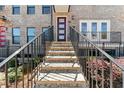 Inviting home entrance up a stone staircase with black railings and a modern door at 2125 Burnside Nw Dr, Atlanta, GA 30318