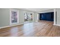 Bright living room featuring wood floors, patio access, and custom built-in shelving at 6851 Roswell Rd # F36, Atlanta, GA 30328