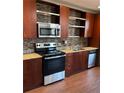 Modern kitchen featuring stainless steel appliances, tile backsplash, and granite countertops at 1342 Rietveld Nw Row, Atlanta, GA 30318