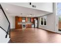 Open living space showcasing the kitchen, hardwood floors, and access to the upper level via modern stairs at 1342 Rietveld Nw Row, Atlanta, GA 30318