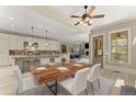 Dining room next to the kitchen features a large wooden table with seating for six at 3405 Camellia Ln, Suwanee, GA 30024