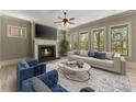 Inviting living room features a fireplace, large windows, and comfortable seating at 3405 Camellia Ln, Suwanee, GA 30024