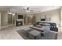 Spacious main bedroom with a fireplace, sitting area, and neutral decor at 3405 Camellia Ln, Suwanee, GA 30024