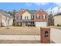 Charming two-story brick and siding home with a well-maintained lawn and an inviting front yard at 907 Hindman Pl, Mcdonough, GA 30253