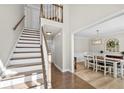 Bright foyer featuring hardwood floors, a staircase, and access to the dining room at 922 Grandview Nw Way, Acworth, GA 30101