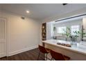 Bright eat-in kitchen features bar seating at the quartz countertop, modern lighting, and a wall-mounted display shelf at 4282 Roswell Ne Rd # G1, Atlanta, GA 30342