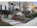 Beautiful townhome with a brick stairway, professional landscaping and a view of the street at 226 Chastain Preserve Ne Ln, Atlanta, GA 30342