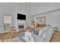 Bright living room with fireplace, hardwood floors, and open layout to dining area at 2461 Lakebrooke Dr, Marietta, GA 30066