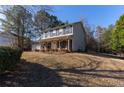 Charming two-story home with a covered porch and manicured lawn in a peaceful, wooded setting at 25 Shadowbrook Ct, Covington, GA 30014