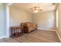 Cozy living room with neutral walls, ceiling fan, and wood-look flooring at 25 Shadowbrook Ct, Covington, GA 30014