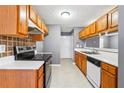 Bright kitchen with light wood cabinets, white countertops, and stainless steel appliances at 6187 Harvard Ct, Morrow, GA 30260