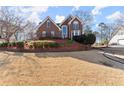 Attractive two-story brick home with manicured lawn and mature trees at 1897 De Winton Pl, Lawrenceville, GA 30043