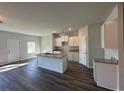 Modern kitchen with white cabinets, granite countertops, and an island with a sink at 8666 Webb Rd, Riverdale, GA 30274