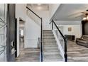 Bright foyer with a grand staircase, featuring wood-look floors and elegant wainscoting at 245 Davenham Ct, Alpharetta, GA 30005