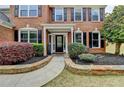 Inviting front entrance with stone-lined walkway, landscaped garden beds, and a classic paneled front door at 245 Davenham Ct, Alpharetta, GA 30005