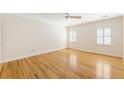 Bright bedroom with wood flooring, white walls, and windows with white shutters at 111 Paces Run, Atlanta, GA 30339