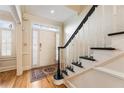 Welcoming front entryway featuring wood floors, stairs with black trim and sidelight windows at 111 Paces Run, Atlanta, GA 30339