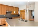 Modern kitchen with stainless steel appliances, wood cabinets, and stone countertops at 111 Paces Run, Atlanta, GA 30339