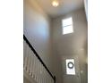 Bright entryway featuring a soaring two-story foyer, front door with decorative wreath, and ample natural light at 83 Nyishol Way, Dallas, GA 30157