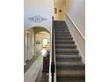 View of a carpeted staircase with white banister and dark wood trim, leading to the upper level at 83 Nyishol Way, Dallas, GA 30157