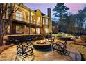 An outdoor oasis with a fire pit and lounge chairs creates the perfect setting for enjoying serene evenings at 2250 Blackheath Trce, Alpharetta, GA 30005