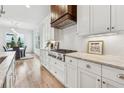 Elegant kitchen with white cabinets, stainless steel appliances, marble countertops, and an eat-in dining area at 4333 Rickenbacker Ne Way, Atlanta, GA 30342
